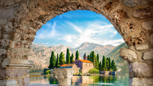 View on St George island from Our Lady of the Rocks through arch. Perast, Montenegro.