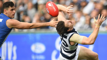 Patrick Dangerfield (right) and Paul Ahern contest possession.