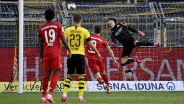 Dortmund goalkeeper Roman Buerki tries in vain to stop Joshua Kimmich's winner during Bayern's 1-0 Bundesliga win over Dortmund.