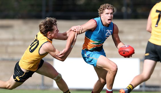 Curtin attempts to bring down Allies forward Jed Walter during the AFL under-18 championships.