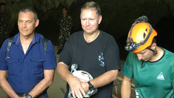 Triumphant return: Craig Challen, Richard Harris and American Joshua David Morris at the entrance to Tham Luang Cave in Thailand in 2019.