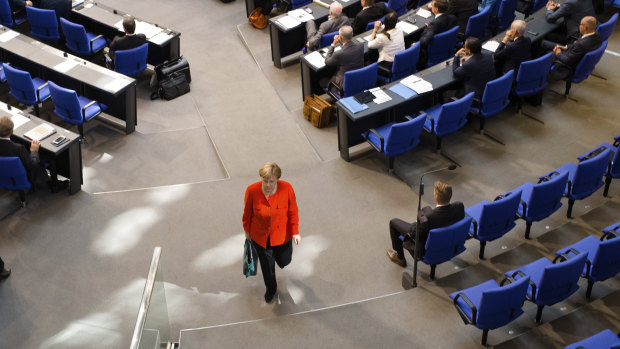 German Chancellor Angela Merkel leaves Parliament after her passionate speech.