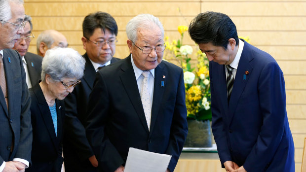 Japanese Prime Minister Shinzo Abe, right, meets with Shigeo Iizuka, second from right, leader of a group of families of Japanese abducted by North Korea, and Sakie Yokota, second from left, mother of Megumi Yokota, one of the Japanese abductees and other members at Abe's official residence in Tokyo in March.