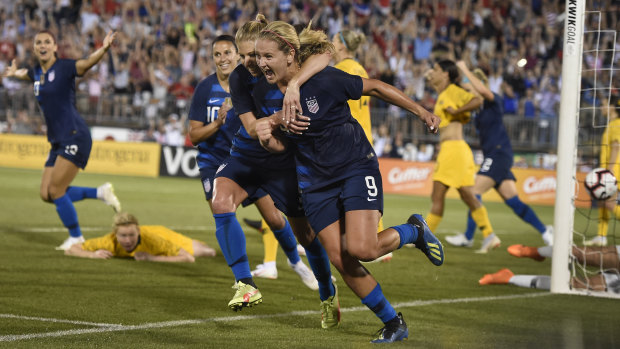 Heartbreaker: United States' Lindsey Horan is hugged by teammate McCall Zerboni after scoring a late equaliser against Australia.