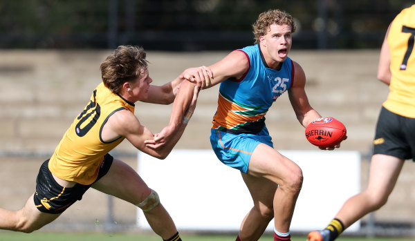 Curtin attempts to bring down Allies forward Jed Walter during the AFL under-18 championships.