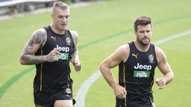Dustin Martin and Trent Cotchin run laps at a recent training session.