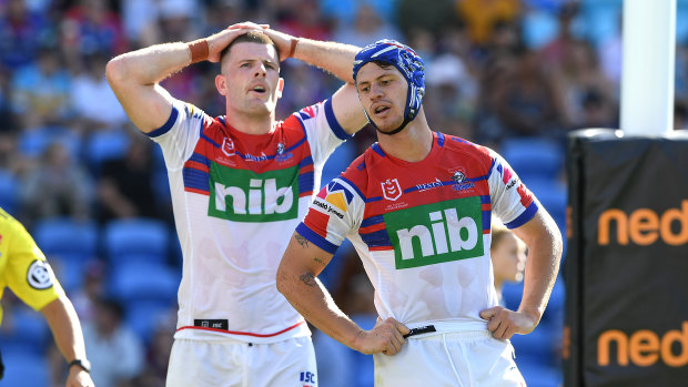 Pressure on: Knights Kalyn Ponga, right, and Lachlan Fitzgibbon after another Titans try on Sunday.