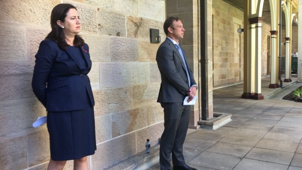 Premier Annastacia Palaszczuk and Health Minister Steven Miles watch as the Chief Health Officer explains her health advice about the Queensland-NSW border.