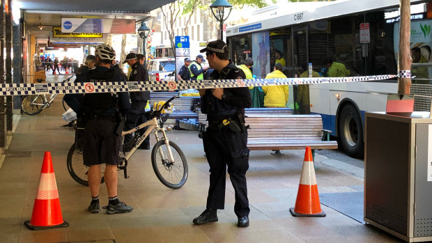 Police cordon off part of Adelaide Street in Brisbane after a woman was hit by a bus on Monday.