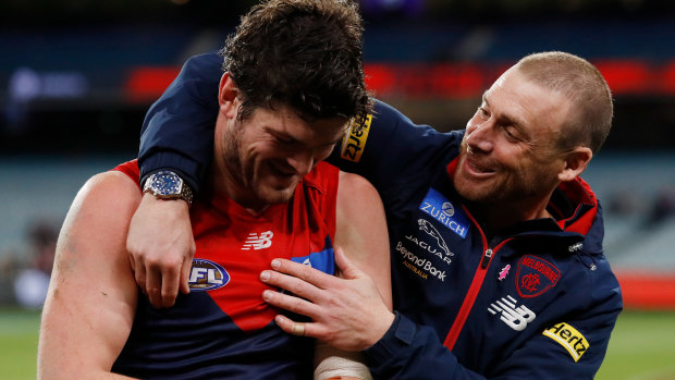 Angus Brayshaw celebrates the Demons’ big win with coach Simon Goodwin.