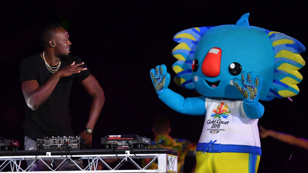 Usain Bolt performs on stage with the Games mascot, Borobi, during the closing ceremony.