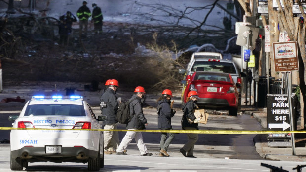 Investigators walk near the scene of an explosion at Nashville, Tennessee. The explosion that shook the largely deserted streets of downtown Nashville early Christmas morning.