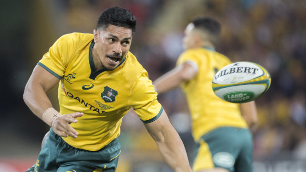 Natural in green and gold: Pete Samu offloads against South Africa in Brisbane.