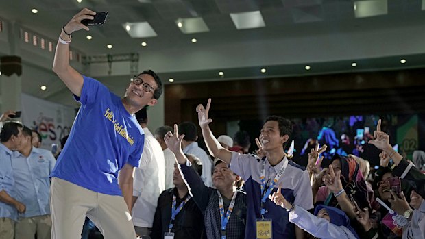 Sandiaga Uno, Prabowo's running mate,  takes a selfie with supporters during a campaign rally in Sragen, Central Java.