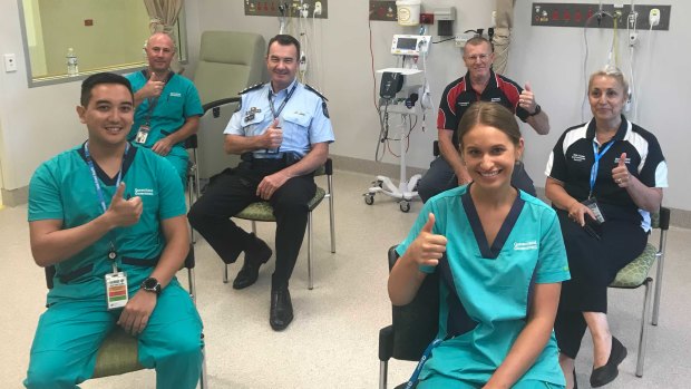 The first six Queenslanders to be vaccinated (clockwise from back left) nurse Ian Cook, Inspector Owen Hortz, wardsman Philip Bayes, cleaner Andrea Perry, nurse Zoe Park and quarantine nurse Kyle Certeza.