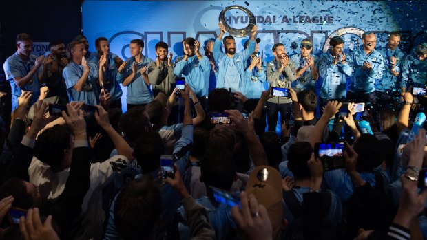 Hail the champs: Fans greet the triumphant Sydney FC team at The Star on Monday night.