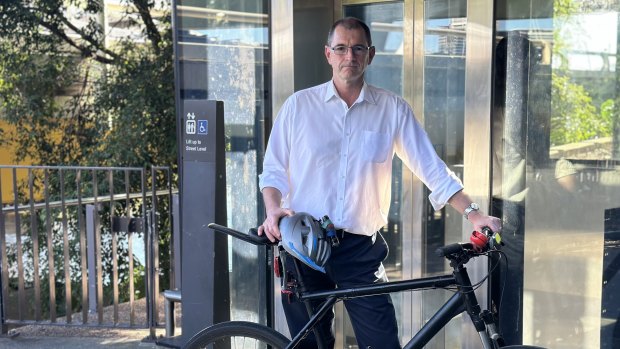 Paul French says he can carry his bike up the stairs, but the frequent outages inconvenience others.