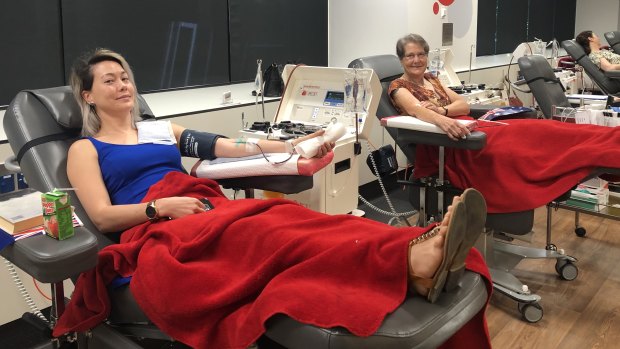 Cordelia (left) and Jennifer Purse, 64 (right) donate blood at the Melbourne CBD Blood Donor Centre on Thursday.