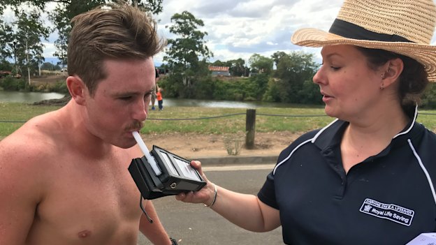 Amy Peden breath-testing a volunteer as part of her research.