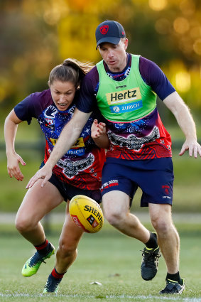 Olivia Purcell goes toe to toe with Demons coach Mick Stinear.