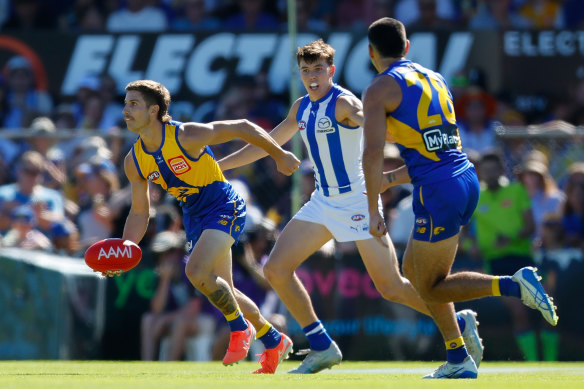 West Coast’s Liam Baker - a two-time premiership winner in his time at Richmond - dishes off a handball.
