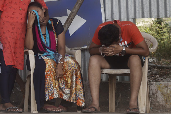 Relatives of a person who died of COVID-19 mourn outside a hospital in Mumbai, India.