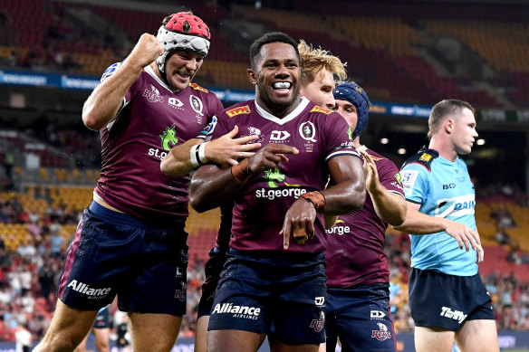 Filipo Daugunu of the Reds celebrates scoring a try during the round one Super Rugby AU match against the New South Wales Waratahs at Suncorp Stadium in 2021.