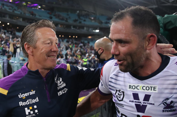 Finally cracking a smile ... Craig Bellamy with Cameron Smith after the grand final triumph.