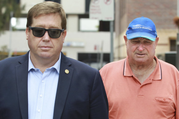 Former NSW police minister Troy Grant leaves Burwood Local Court with his father Kenneth Grant who appeared on charges relating to a hit-and-run road death. 