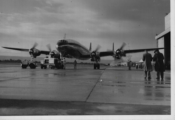 A Qantas Super Constellation aircraft prepares to move towards the runway to take off for Singapore on the inaugural flight of the new service from Sydney to London via Perth, 1955.