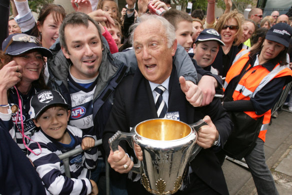 Frank Costa is mobbed by fans in 2007 after Geelong’s premiership.