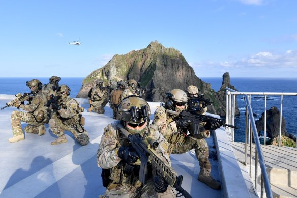 Members of the South Korean Navy's special forces participate in a drill on islets called Dokdo in Korean and Takeshima in Japanese.