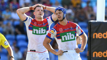 Pressure on: Knights Kalyn Ponga, right, and Lachlan Fitzgibbon after another Titans try on Sunday.