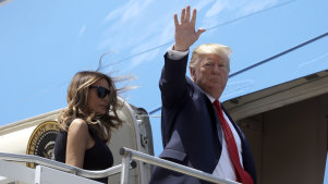 President Donald Trump and first lady Melania Trump board Air Force One.