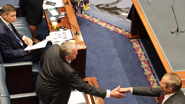Roger Cook shakes Shane Love’s hand.