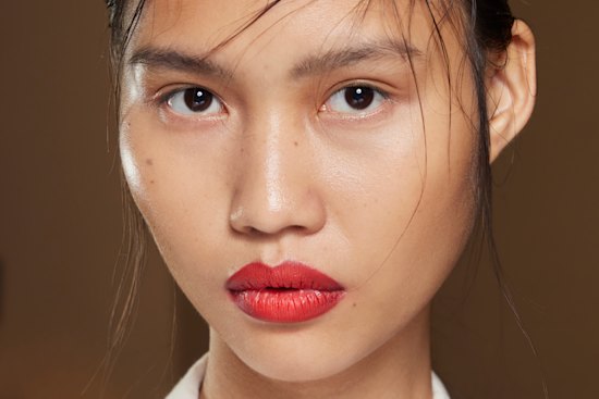 Make-up artist Diane Kendal used a punchy red lip with a backdrop of fresh dewy skin and a nude eye for this look.