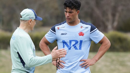 Joseph Suaalii chatting to coach Joe Schmidt in camp with the Wallabies.
