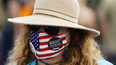 A supporter of President Donald Trump attends a rally outside the Maricopa County Recorder's Office where elections officials continue to count ballots for the general election.