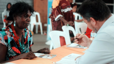 A Palm Island resident works with an ICAN financial counsellor. ICAN wants to see finance hubs set up in remote locations as part of a national strategy.