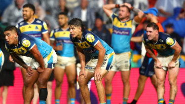 Gold Coast Titans players await the decision on the golden-point try.