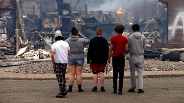 A fire smoulders at a destroyed fast food restaurant near the Minneapolis Police Third Precinct on Thursday morning.
