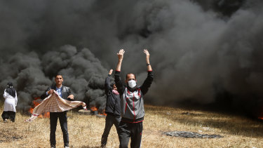 Palestinian protesters call others to bring more tyres to burn during clashes with Israeli troops along Gaza's border with Israel.