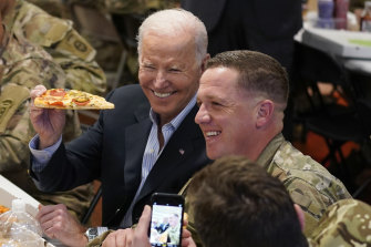 US President Joe Biden poses for a photo during a visit to the 82nd Airborne Division in Jasionka, Poland. 