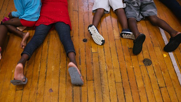 A group of children, who are part of a sudden influx of asylum seekers arriving in Portland, Maine, play in a makeshift shelter.
