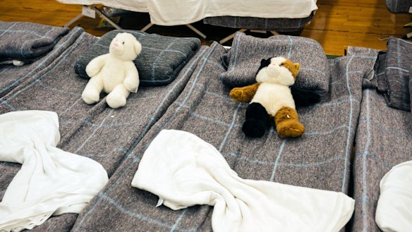Sleeping cots and personal items belonging to asylum seekers at the Expo, a municipally owned basketball arena in Portland.