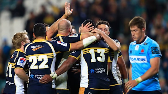 The Brumbies celebrate victory against the Waratahs.