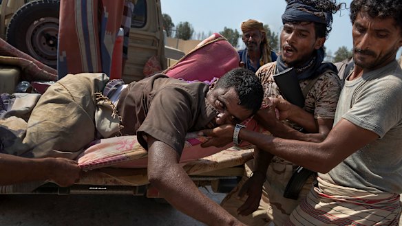 An injured Yemeni fighter with the Saudi Arabia-led Arab coalition, which is battling Iran-backed Houthis for control of Yemen, arrives at a field hospital.