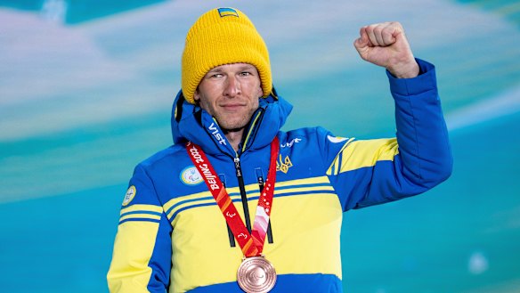 Ukrainian bronze medallist Grygorii Vovchynskyi gestures to the crowd during his medal ceremony.