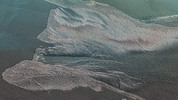 Oil-slicked waters spread out from the partially sunk Iranian navy vessel.