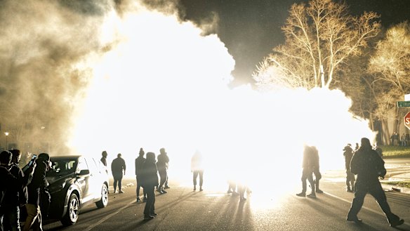 Authorities use flash bombs to disperse the crowd.